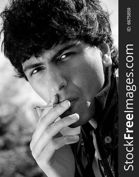 Black and white portrait of smoking arabic guy