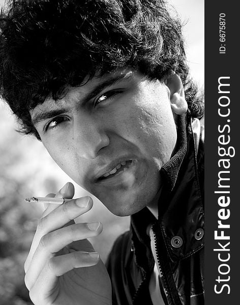 Black and white portrait of smoking arabic guy