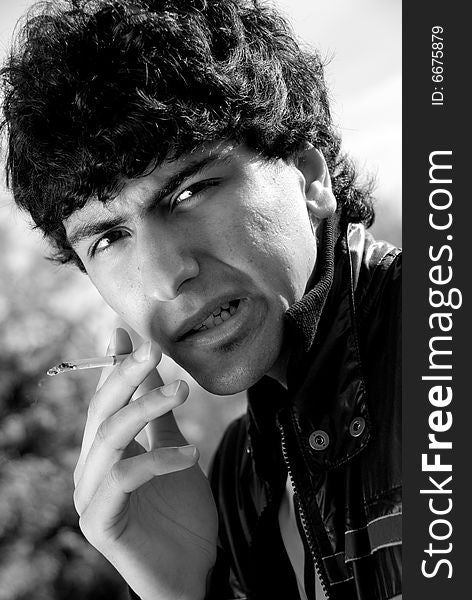 Black and white portrait of smoking arabic guy