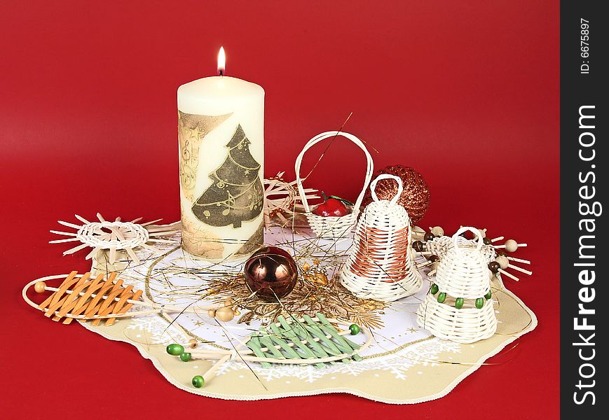 Christmas still life  with wicker decorations and candle. Christmas still life  with wicker decorations and candle