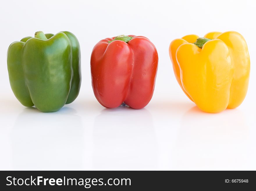 Red green and yellow pepper on white background. Red green and yellow pepper on white background