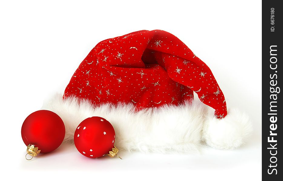 Close up of a Santa Claus hat and two spheres. Close up of a Santa Claus hat and two spheres