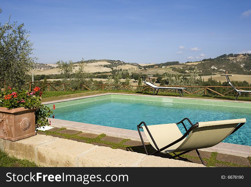 The garden of a luxury country house in the famous Tuscan hills, Italy. Focus on Olive's branch. The garden of a luxury country house in the famous Tuscan hills, Italy. Focus on Olive's branch