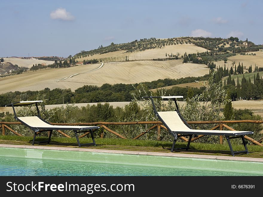 Chairs in the garden of a luxury country house in the famous tuscan hills, Italy. Chairs in the garden of a luxury country house in the famous tuscan hills, Italy.