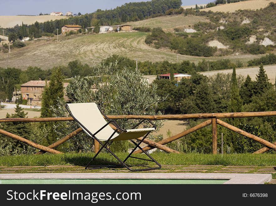 Chairs in the garden of a luxury country house in the famous tuscan hills, Italy. Chairs in the garden of a luxury country house in the famous tuscan hills, Italy.