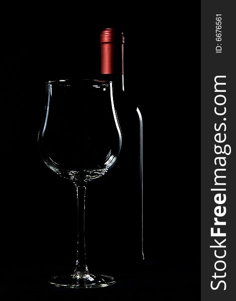 Wine bottle and glass on black backgrounds