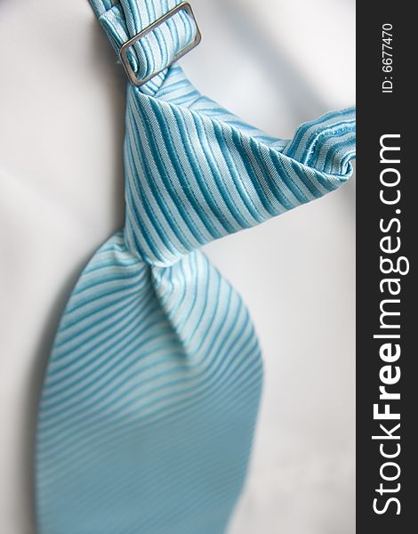 Fresh bright striped blue tie ready to be worn by the groom for a summer wedding. Fresh bright striped blue tie ready to be worn by the groom for a summer wedding