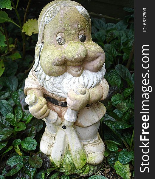 A very old weathered garden gnome