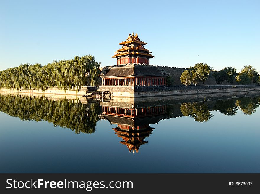 Turret, wall, willows and their reflections in moat, shot at northeast corner of forbidden city, Beijing China. Turret, wall, willows and their reflections in moat, shot at northeast corner of forbidden city, Beijing China.