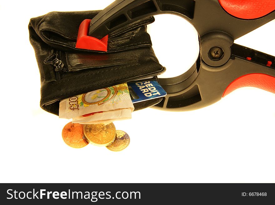 Wallet held in a clamp with credit card and british pound coins/notes. Wallet held in a clamp with credit card and british pound coins/notes