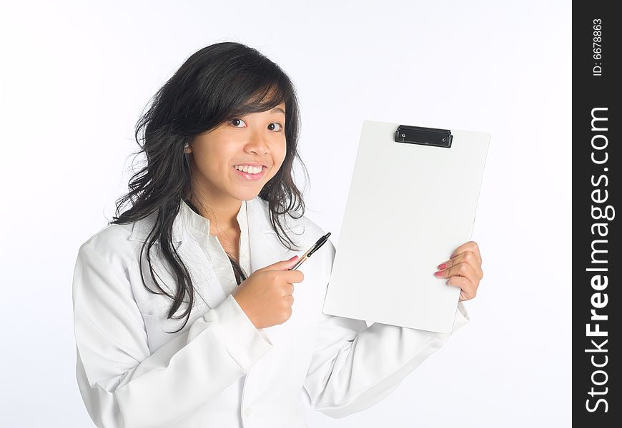 Young woman in white overalls pointing at a clipboard - with copyspace - during a presentation. Young woman in white overalls pointing at a clipboard - with copyspace - during a presentation