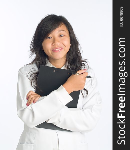 Young smiling happy woman in white overalls and holding a clip board during a presentation. Young smiling happy woman in white overalls and holding a clip board during a presentation