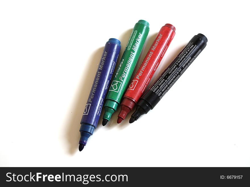 Office pens with different colors on white background