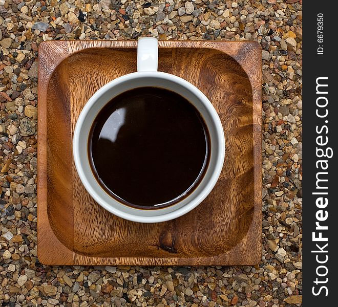 Cup of coffee  top view, on a wooden square plate