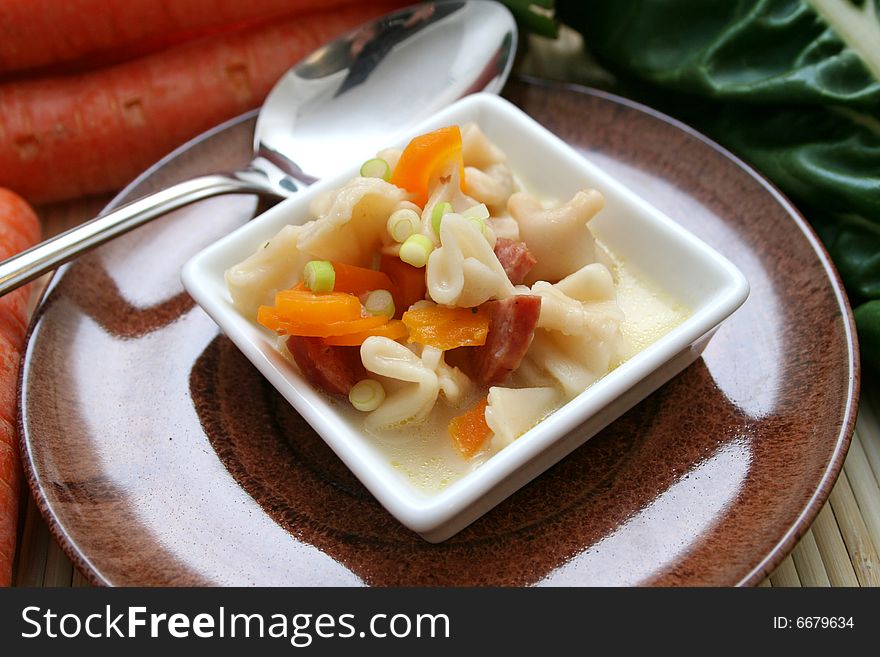 A soup of fresh tofu noodles with vegetables