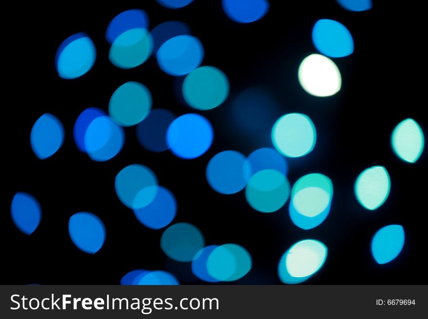 Defocused blue Christmas lights, as holiday background