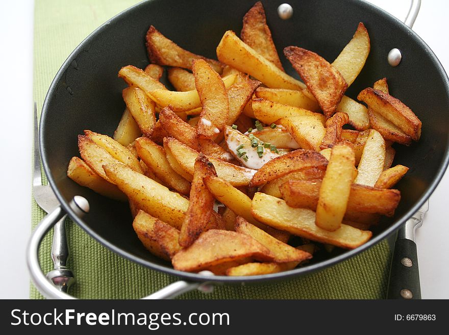 Some fresh potatoes slices in a pan. Some fresh potatoes slices in a pan