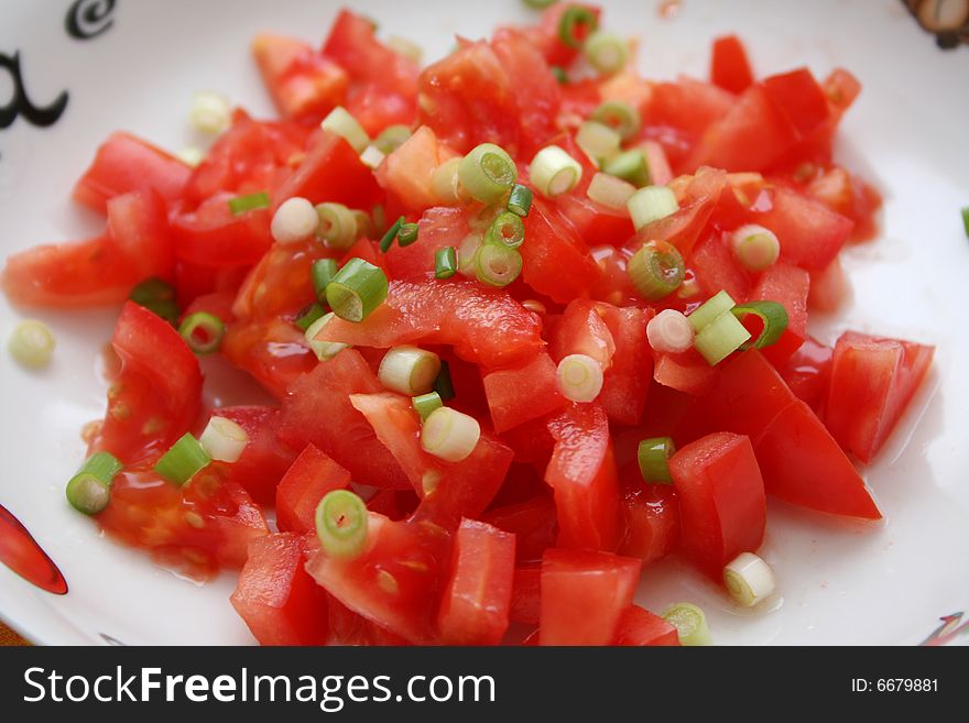 A salad of fresh tomatoes with onions
