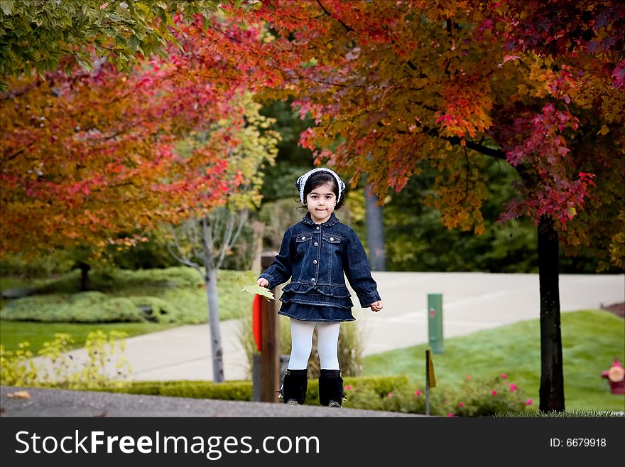 Girl And Red Autumn Trees