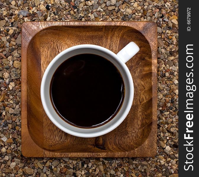 Cup of coffee top view on wooden square plate