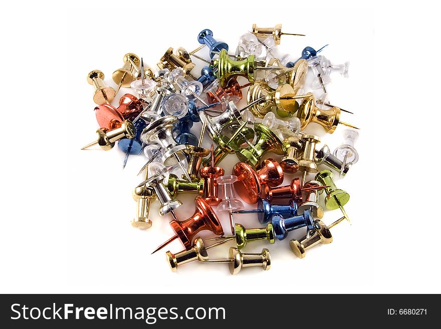 Colorful metallic push pins in a pile on a white background. Colorful metallic push pins in a pile on a white background.