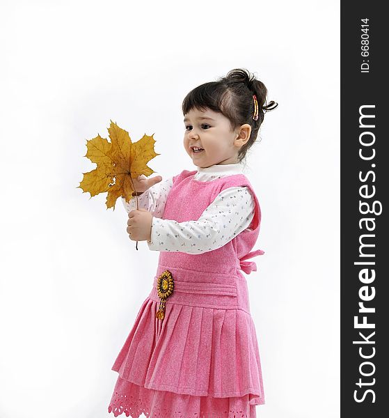 The little girl is holding in his hand upavshy leaf from a tree