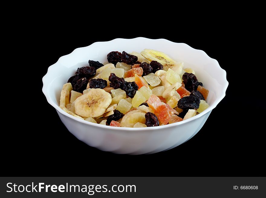 Fruit mixture in china plate on black