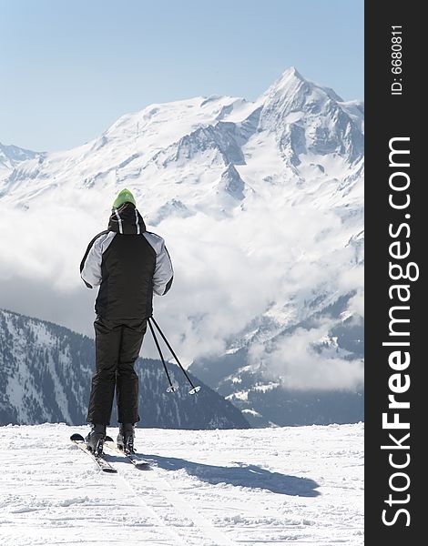 Skier takes a break; in background the french alps, Europe.