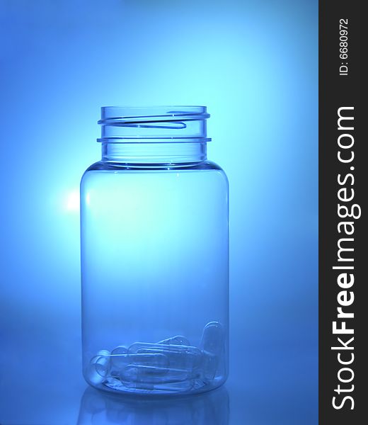 Bottle with capsules in the blue light