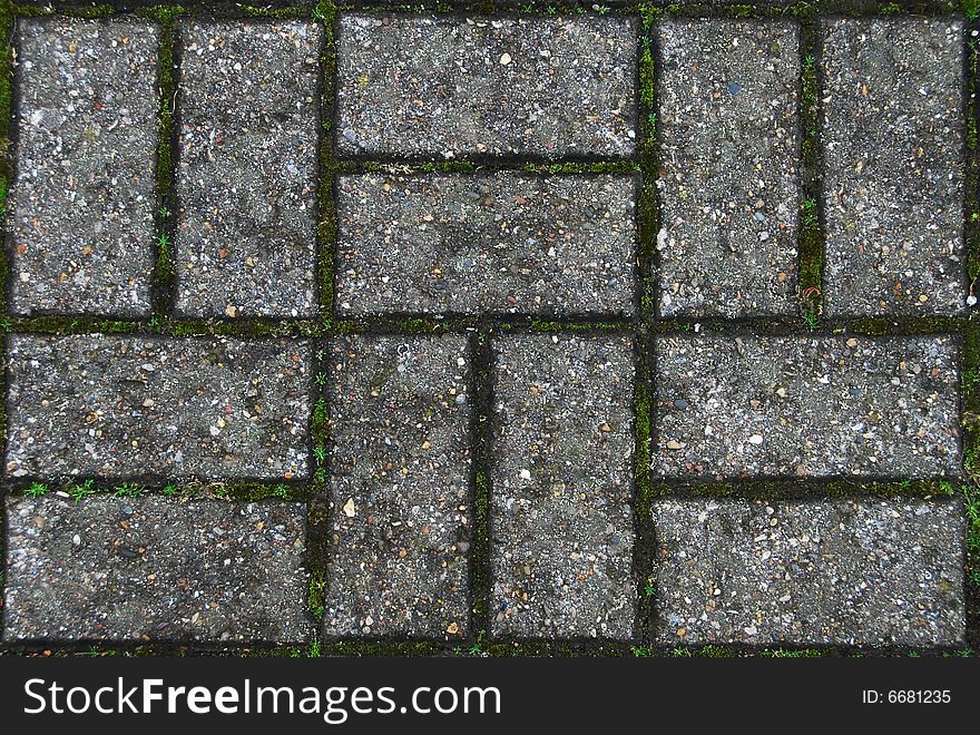 A patterned walkway with moss growing in between the bricks. Can be tiled up seamlessly to make a larger graphic background. A patterned walkway with moss growing in between the bricks. Can be tiled up seamlessly to make a larger graphic background.