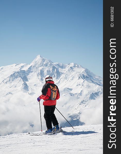 Skier takes a break; in background the french alps, Europe.