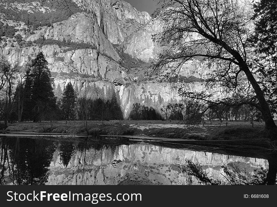 Image of winter reflections captured in Yosemite National Park. The winter flow of lower Yosemite Falls is seen in the distance. Image of winter reflections captured in Yosemite National Park. The winter flow of lower Yosemite Falls is seen in the distance.