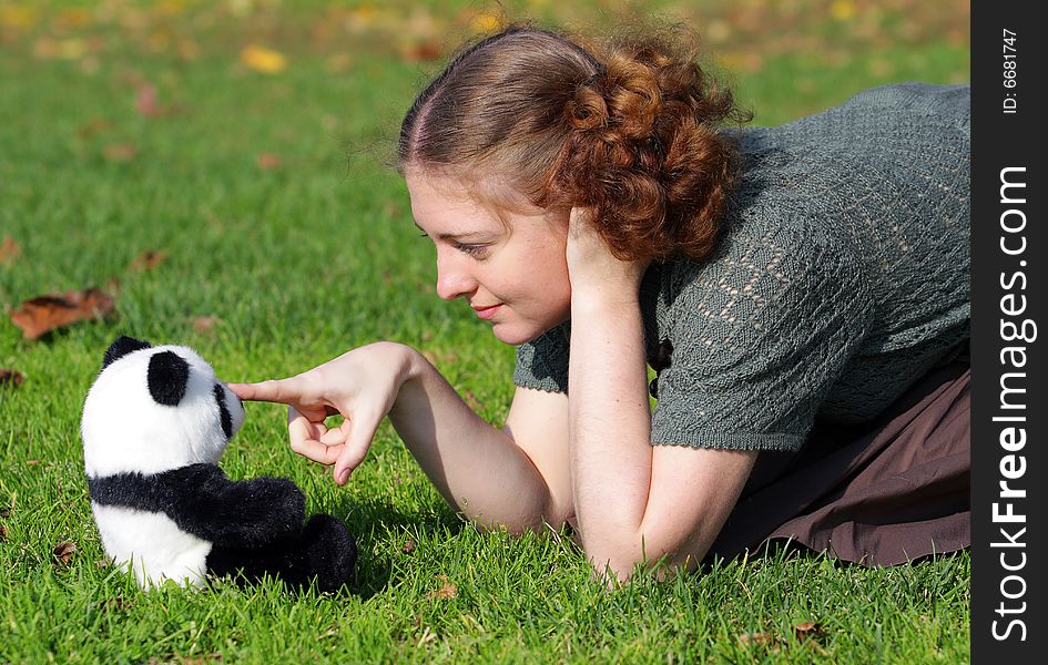 Girl is payin with the toy on green grass. Girl is payin with the toy on green grass