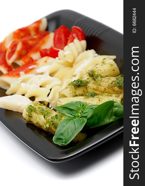 Typical italian pasta arranged with italy flag colors and typical ingredients, pesto, grana, and tomato - shallow dof. Typical italian pasta arranged with italy flag colors and typical ingredients, pesto, grana, and tomato - shallow dof