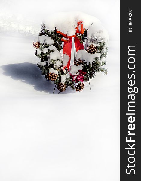 Christmas Holiday Wreath Covered in Snow and Red Ribbons. Christmas Holiday Wreath Covered in Snow and Red Ribbons