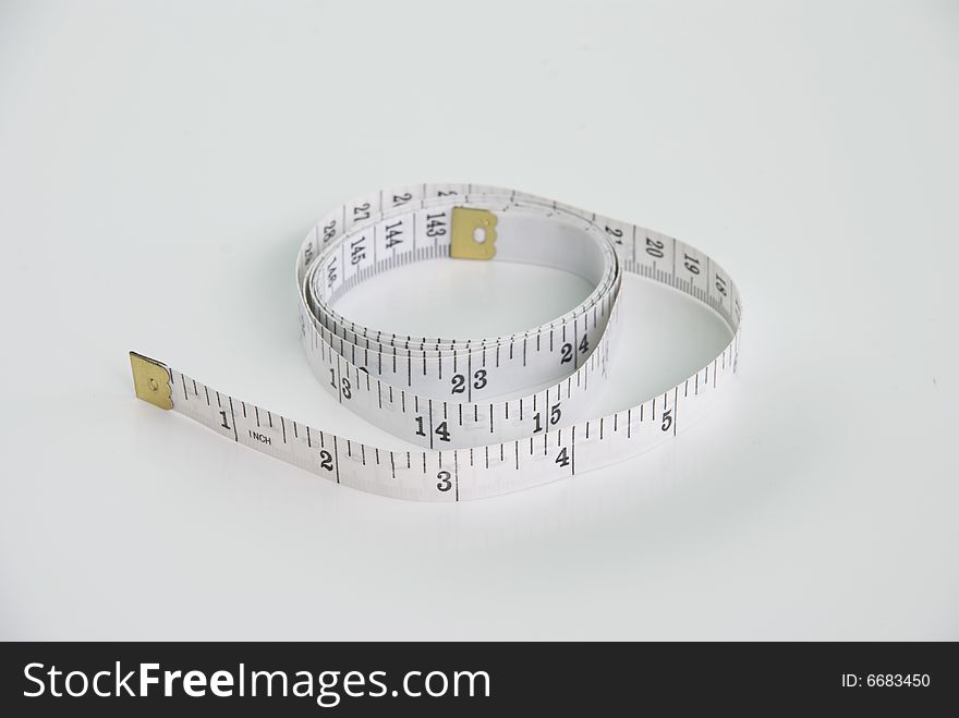 A isolated white tape measure shot on a white background. A isolated white tape measure shot on a white background