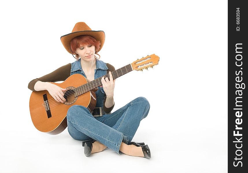 Woman sitting on a floor and playing guitar. Woman sitting on a floor and playing guitar