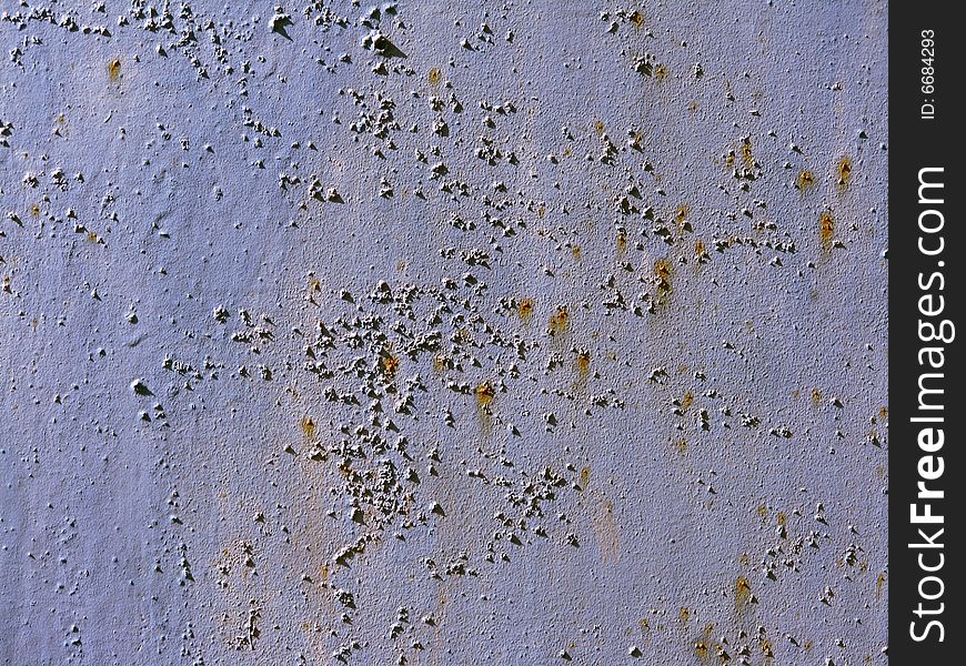 Painted metallic sheet with the signs of corrosion