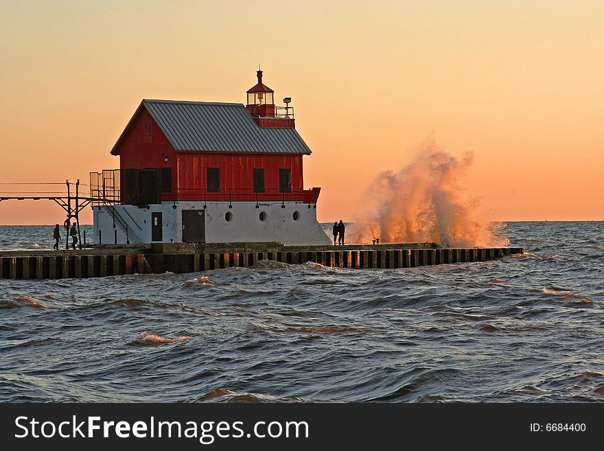 A large wave breaking over the south pier lighthouse at Grand Haven, MI. A large wave breaking over the south pier lighthouse at Grand Haven, MI