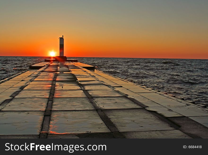 A vivid sunset in fall at the north pier, Grand Haven, MI. A vivid sunset in fall at the north pier, Grand Haven, MI