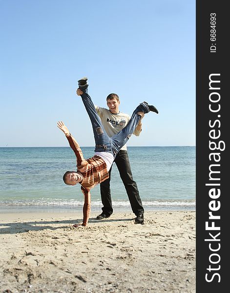 Two young men enjoying life on the sea shore. Two young men enjoying life on the sea shore