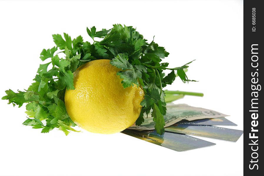 The lemon with the verdure rests upon  the money