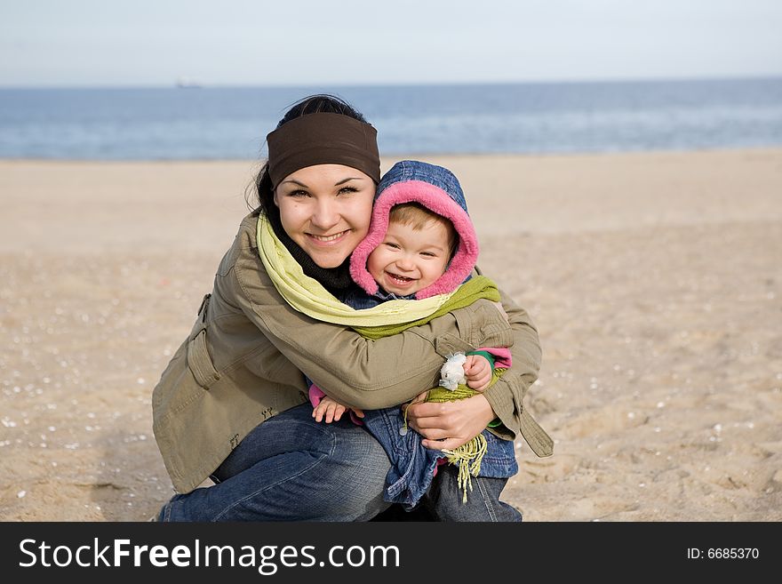 Mother and daughter together on the beach. Mother and daughter together on the beach