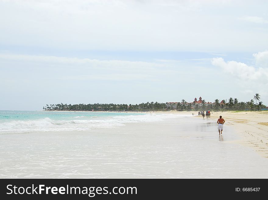 A running on the sand of a tropical beach. A running on the sand of a tropical beach