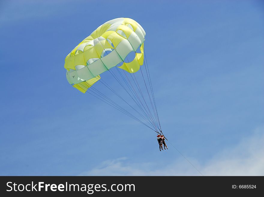 Boat driven parachute flight against blue sky