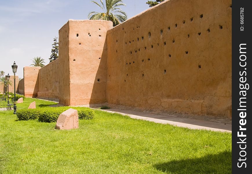 Part of city big wall in Marrakech, Morocco. Sunny summer day. Part of city big wall in Marrakech, Morocco. Sunny summer day.