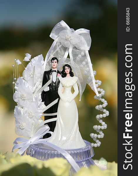 Wedding cake with a bride & groom statue on top. Wedding cake with a bride & groom statue on top.