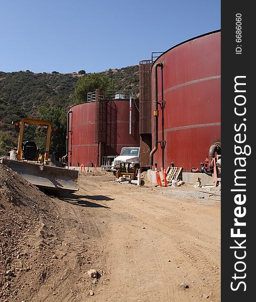 Red primed water storage tanks under construction