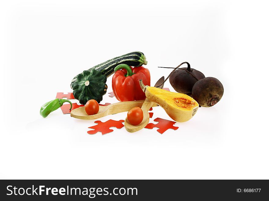 Arrangement of a pumpkin, beet of pepper and wooden spoons. Arrangement of a pumpkin, beet of pepper and wooden spoons