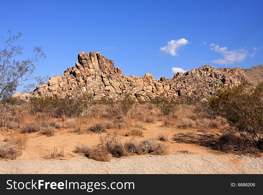 Red rock formation in the desert under a vivid blue sky